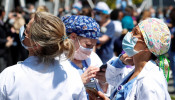 Healthcare workers from the NYU Langone Medical Center wait the U.S. Navy Blue Angels and U.S. Air Force Thunderbirds demonstration teams to participate in a midday flyover of the New York City 