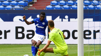 FC Augsburg's Andreas Luthe saves from Schalke 04's Rabbi Matondo, as play resumes behind closed doors following the outbreak of the coronavirus disease (COVID-19)