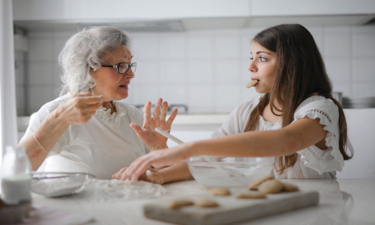 Grandmother and granddaughter bonding while baking. 