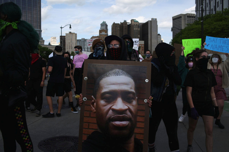 A protestor holds a photo of George Floyd during a protest against the death in Minneapolis police custody of African-American man George Floyd