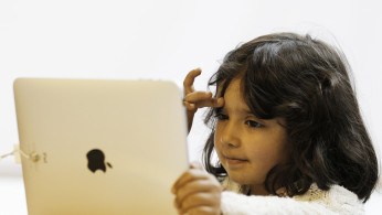 A girl views a new iPad tablet computer at an Apple store during its UK launch in central London May 28, 2010.