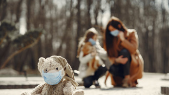 Teddy bear wearing surgical mask.
