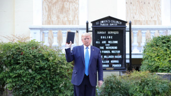 U.S. President Donald Trump holds up a Bible as he stands in front of St. John's Episcopal Church across from the White House