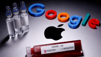 A test tube with fake blood and COVID-19 label and a 3D printed Google logo