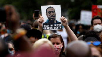 People attend a public memorial after the death in Minneapolis police custody of George Floyd in the Brooklyn borough of New York City