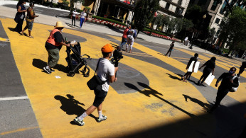 People gather on the street where 