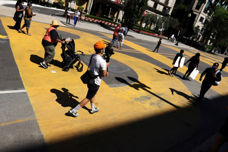 People gather on the street where "Black Lives Matter" is painted in yellow near Lafayette Square at the scene where protesters clashed with police near the White House in Washington