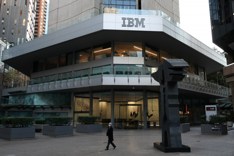 A man wearing a protective mask walks past an office building with IBM logo amidst the easing of the coronavirus disease (COVID-19) restrictions in Sydney