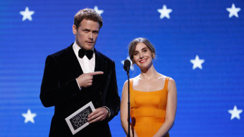 Sam Heughan and Alison Brie on stage