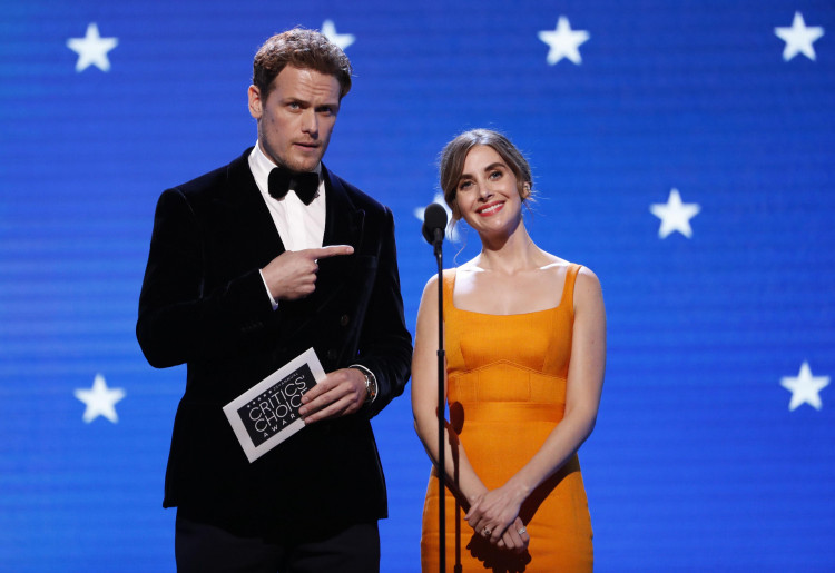 Sam Heughan and Alison Brie on stage