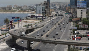 Cars drive along a highway in Jal el-Dib
