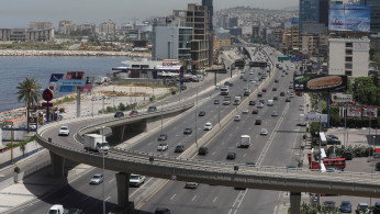 Cars drive along a highway in Jal el-Dib