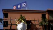 An abandoned mask is seen on a fence in front of H10 Costa Adeje Palace hotel, which is under lockdown over the coronavirus outbreak in Adeje