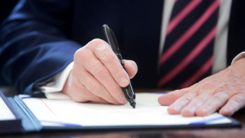 FILE PHOTO: U.S. President Trump signs the Paycheck Protection Program and Health Care Enhancement Act response to the coronavirus disease outbreak at the White House in Washington