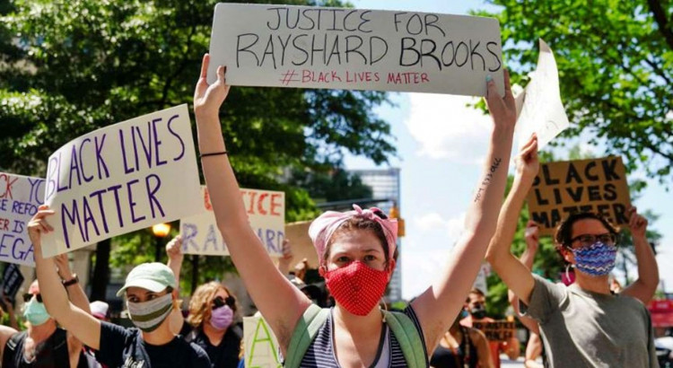 Protesters rally against racial inequality and the police shooting death of Rayshard Brooks