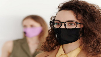 Woman wearing eyeglasses with face mask.
