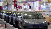 FILE PHOTO: Tesla China-made Model 3 vehicles are seen during a delivery event at its factory in Shanghai