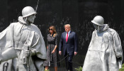 U.S. President Donald Trump and first lady Melania Trump walk past statues as they arrive for a wreath laying ceremony at the Korean War Veterans Memorial in Washington, U.S., June 25, 2020. REUTERS/Tom Brenner