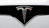 FILE PHOTO: The Tesla logo is seen on a car at Tesla's showroom in Manhattan's Meatpacking District in New York