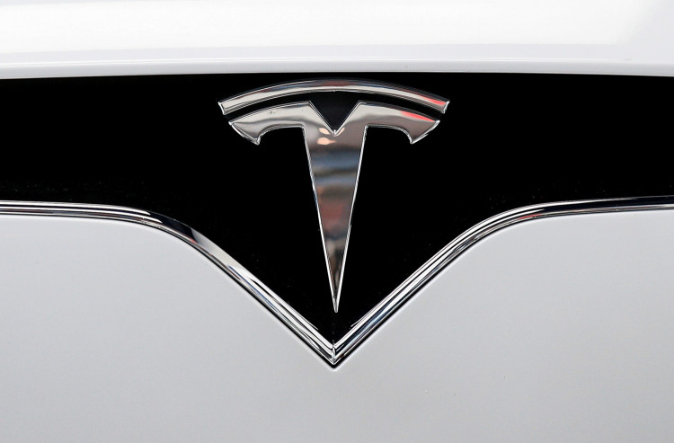 FILE PHOTO: The Tesla logo is seen on a car at Tesla's showroom in Manhattan's Meatpacking District in New York