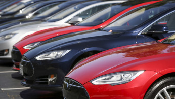 FILE PHOTO: A row of Tesla Model S sedans are seen outside the company's headquarters in Palo Alto, California April 30, 2015. 