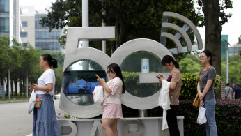 Employees wait for a shuttle bus at a 5G testing park at Huawei's headquarters in Shenzhen, Guangdong province, China May 29, 2019. 