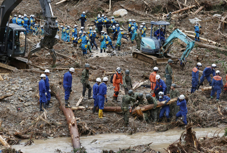 Rescue workers search for missing people at a landslide site