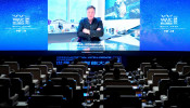 Tesla Inc Chief Executive Officer Elon Musk is seen on a screen during a video message