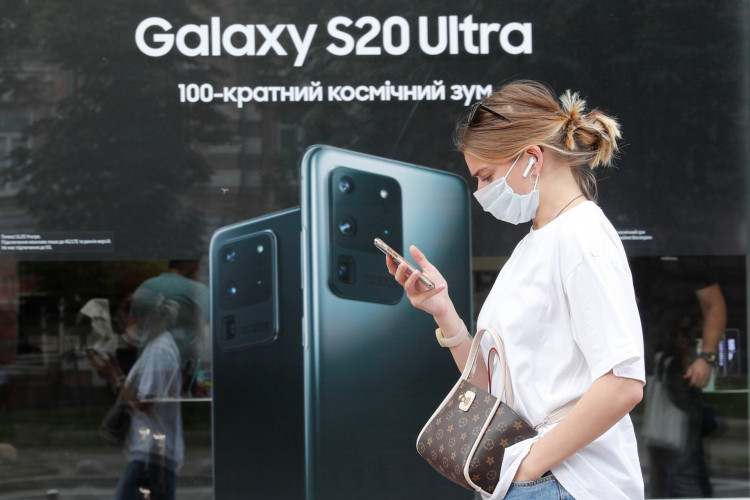 A woman walks past a Samsung brand store in central Kyiv