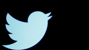 The Twitter logo is displayed on a screen on the floor of the New York Stock Exchange (NYSE) in New York City