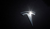 FILE PHOTO: The Tesla logo is seen on a car in Los Angeles, California, U.S., July 9, 2020. 