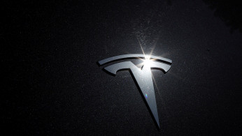 FILE PHOTO: The Tesla logo is seen on a car in Los Angeles, California, U.S., July 9, 2020. 