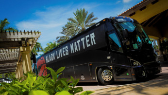 A bus carrying the NBA champions Toronto Raptors basketball team arrive at the Walt Disney World complex