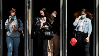 FILE PHOTO: People wearing protective face masks amid the outbreak of the coronavirus disease (COVID-19) walk out of a metro station in Kyiv, Ukraine July 15, 2020.