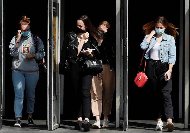 FILE PHOTO: People wearing protective face masks amid the outbreak of the coronavirus disease (COVID-19) walk out of a metro station in Kyiv, Ukraine July 15, 2020.