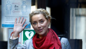 Actor Amber Heard waves as she arrives at the High Court