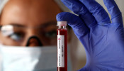 FILE PHOTO: Fake blood is seen in test tubes labelled with the coronavirus (COVID-19) in this illustration taken March 17, 2020.