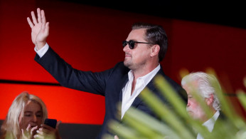 Cast member Leonardo DiCaprio waves as he arrives for the Berlin premiere of 