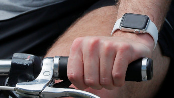 A bicyclist wearing a smart watch