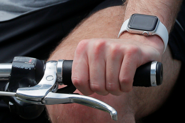 A bicyclist wearing a smart watch