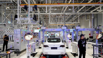 FILE PHOTO: Tesla China-made Model 3 vehicles are seen during a delivery event at its factory in Shanghai