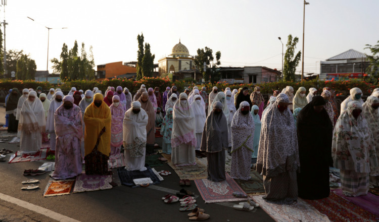 Indonesian Muslims offer Eid al-Adha prayers on the street in Jakarta, 