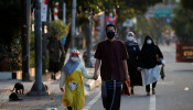 Indonesian Muslims walking to Eid al-Adha prayers wearing face masks