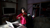 Marcela, 12, member of the Buenos Aires children's and youth orchestra program, practices her violin during a video call at home during the coronavirus pandemic