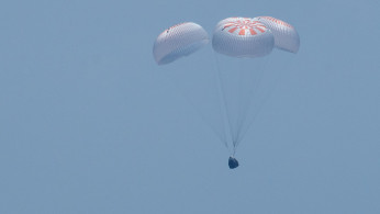The SpaceX Crew Dragon Endeavour spacecraft is seen as it lands with NASA astronauts Robert Behnken and Douglas Hurley onboard