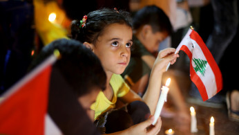 Palestinians light candles to show solidarity