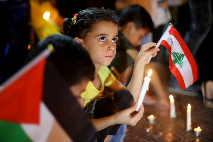 Palestinians light candles to show solidarity