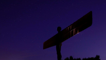 The stars shine in the sky above Antony Gormley's Angel