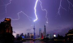 Lightning strikes are seen above the skyline of Shanghai