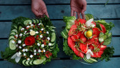 A waiter presents two types of salad served by Habibi restaurant in Peshawar, Pakistan January 31, 2018.
